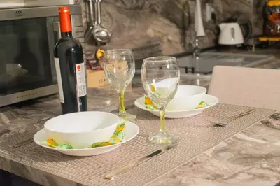 a table with two glasses and a bottle of wine at Nelly's Place 10 in Shkorpilovtsi