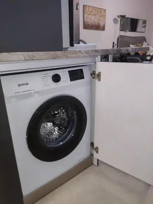 a white washing machine sitting in a kitchen at Nelly's Place 10 in Shkorpilovtsi