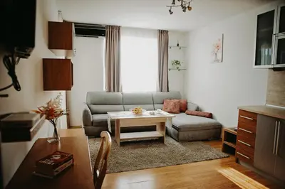a living room with a couch and a table at Smile City Apartment in Varna City