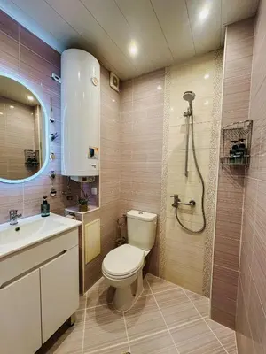 a bathroom with a toilet and a sink and a shower at Smile City Apartment in Varna City