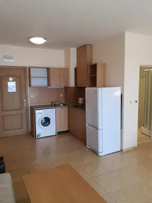 a kitchen with a refrigerator and a washing machine at Trakia Plaza Apartments in Sunny Beach