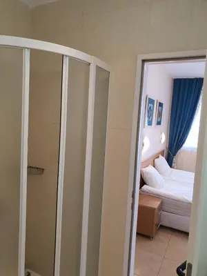 a room with a bedroom with a bed and a mirror at Trakia Plaza Apartments in Sunny Beach