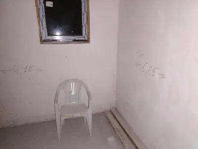 a chair sitting in a corner of a room with writing on the wall at Amadeus 19 in Sunny Beach
