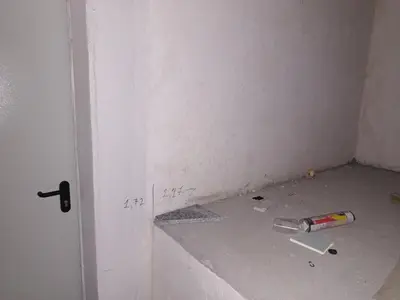 a bottle on the floor in a room with a wall at Amadeus 19 in Sunny Beach
