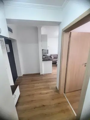 an empty room with a hallway leading to a living room at Апартамент Дани in Obzor