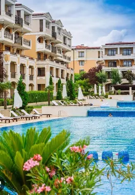 a swimming pool in front of a building at Студио в Затворен Комплекс Green in Sozopol