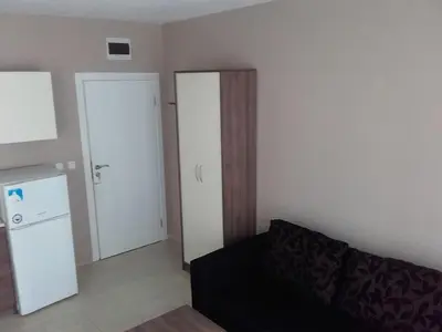 a living room with a couch and a refrigerator at SUN GATE - Julia in Sunny Beach