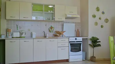 a kitchen with white cabinets and a stove top oven at Апартамент Деа - Apartment Dea in Byala