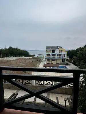 a view of a beach with a house and the ocean at Relaxing apartment - 100 meters from the sea in Chernomorets