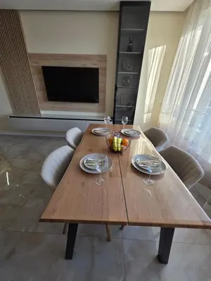 a wooden table with wine glasses on it in a living room at Арена Изгрев in Burgas City