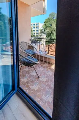a balcony with a chair and a table on a patio at Bella Mare Boutique apartment in Sunny Beach