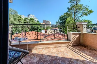 a balcony with a table and a wrought iron railing at Bella Mare Boutique apartment in Sunny Beach