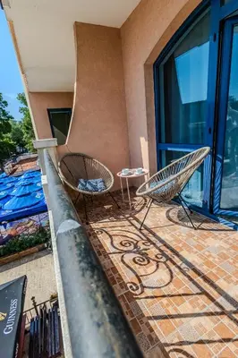 a balcony with two chairs and a table at Bella Mare Boutique apartment in Sunny Beach