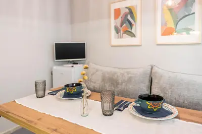 a wooden table with two cups and plates on it at Vera Sweet Home in Varna City