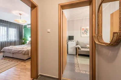 a hallway with a mirror and a bedroom at Vera Sweet Home in Varna City