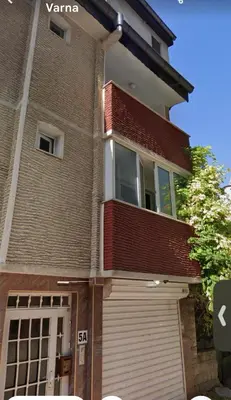 a house with a garage door and a building at Vera Sweet Home in Varna City