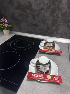 a counter top with two plates and two cups on it at Sea in Varna City