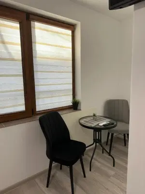 a room with a chair and a table and a window at Sea in Varna City