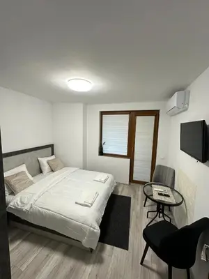 a bedroom with a bed and a table and a tv at Star in Varna City
