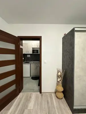 a hallway with a door leading to a kitchen at Star in Varna City