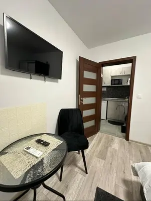 a room with a table and a chair and a television at Star in Varna City