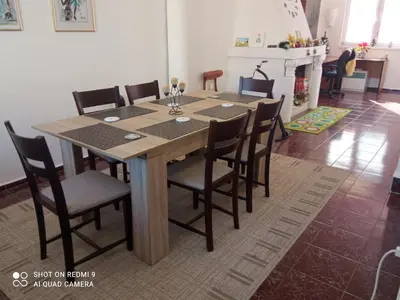 a wooden table and chairs in a room at International 2-star spacious 88 sq m apartment in Varna City