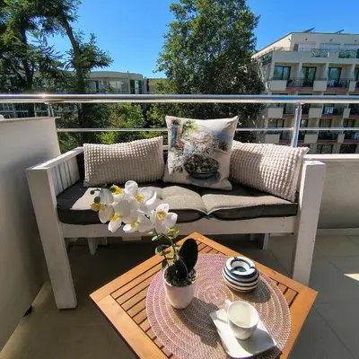 a balcony with a couch and a table on a balcony at Slavi studios Aparthotel Exselsior, Sunny beach in Sunny Beach