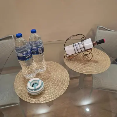 two bottles of water sitting on a table with a hat at Slavi studios Aparthotel Exselsior, Sunny beach in Sunny Beach