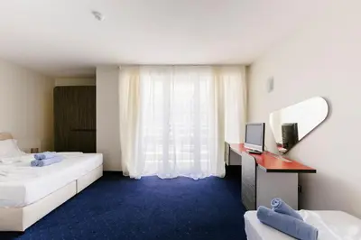 a hotel room with two beds and a window at APOLONIS hotel in Sozopol