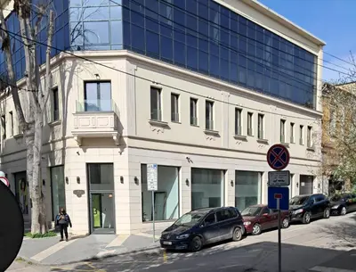 a building with cars parked on a city street at Varna Moreto in Varna City