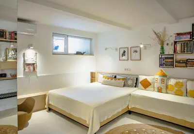 a bedroom with a bed and a window and shelves at Villa Mare Boutique Guesthouse by Flat Mаnаger in Pomorie