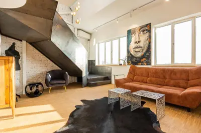 a living room with a couch and a staircase at Apartment Musala N 01 in Varna City