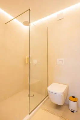 a bathroom with a toilet and a glass shower at Apartment Musala N 01 in Varna City