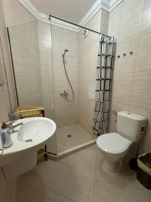a bathroom with a shower and a toilet and a sink at Апартамент с одной спальней in Sunny Beach