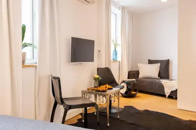 a living room with a table and a couch at Apartment Musala N 02 in Varna City
