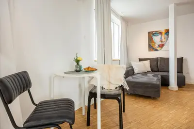 a living room with a table and a couch at Apartment Musala N 03 in Varna City