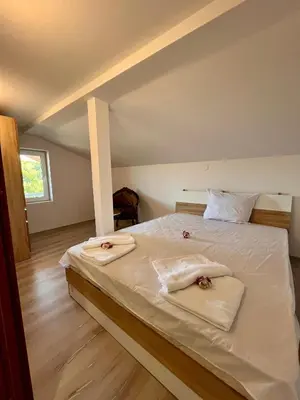 a bedroom with a bed with towels on it at Villa Teos in Novo Panicharevo