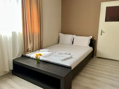 a bed with a vase of flowers on top of it at Villa Teos in Novo Panicharevo