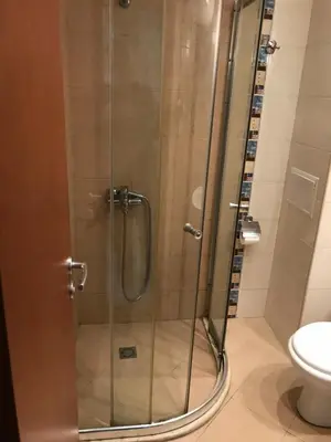 a shower with a glass door in a bathroom at Lozenetz Beach Apartments in Lozenets