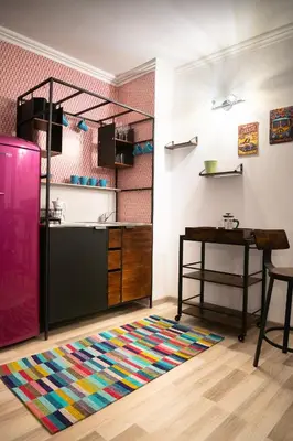 a kitchen with a table and a colorful rug at Zen Studio - Oasis Beach Club in Lozenets