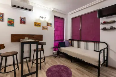 a bedroom with purple doors and a bed and stool at Zen Studio - Oasis Beach Club in Lozenets