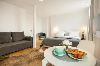 a room with a bed and a table with a tray of food at Apartment Musala N 04 in Varna City