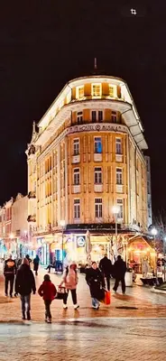 a group of people walking in front of a large building at Apartment Musala N 04 in Varna City