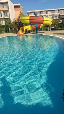 a water slide in a swimming pool at Holiday Fort Golf Club & Orchid Fort Noks MIA in Sunny Beach
