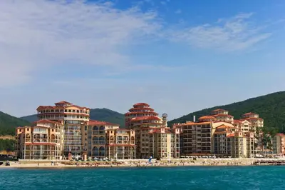 a group of hotels on a beach next to the water at Menada Atrium Beach Apartments in Elenite