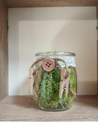 a jar filled with green moss and a key at Dream Loft in the center of Varna in Varna City