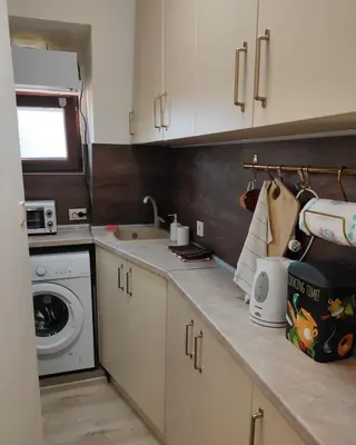 a kitchen with a sink and a washing machine at Dream Loft in the center of Varna in Varna City