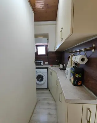 a small kitchen with a sink and a washing machine at Dream Loft in the center of Varna in Varna City
