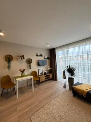 a living room with a bed and a table and chairs at Orchid Fort Noks Design in Sunny Beach