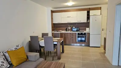 a kitchen and dining room with a table and chairs at Vladan apartments in Sozopol